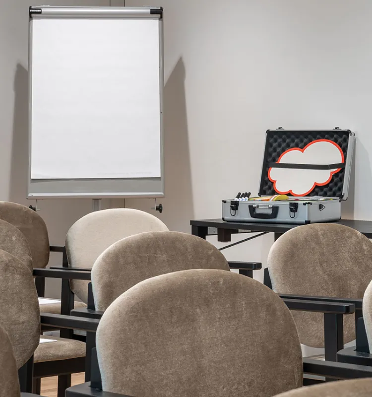 Moderationskoffer und Stuhlreihen im Grand Elisabeth Bad Ischl mit Flipchart im Hintergrund